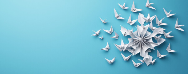 Christmas origami birds and snowflake create festive winter scene on blue background with peaceful joyful holiday atmosphere
