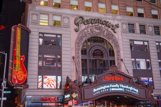 Historic Paramount building hosting Hard Rock Cafe restaurant at Times Square with its billboards at night in Midtown Manhattan,  New York City, USA