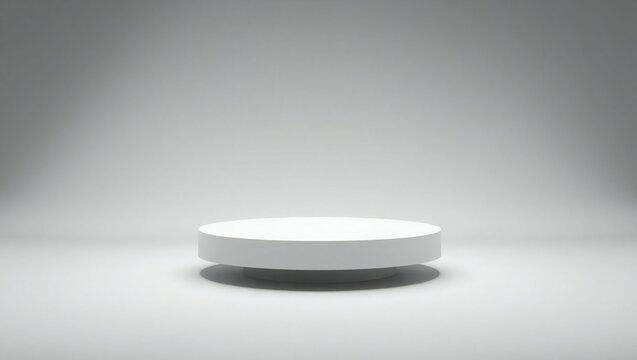 Clean white circular podium with soft spotlight illumination on a grey background