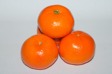 Three Vibrant Mandarin Oranges Stacked Pyramid Style