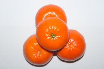 Four Bright Whole Mandarin Oranges Grouped Together
