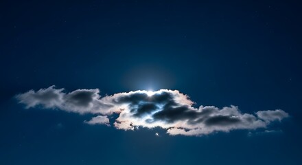 A cloud illuminated by the moon in the night sky with stars above
