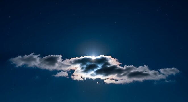 A cloud illuminated by the moon in the night sky with stars above