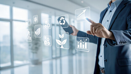 Businessman pointing at holographic environmental icons including recycling plant CO2 growth chart in futuristic office with large windows