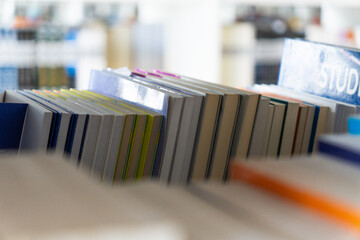 Photograph taken from the back of a bookshelf with books of different sizes