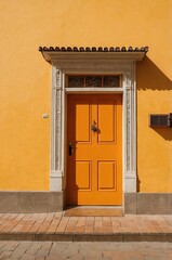 Fototapeta premium Portrait of orange door on yellow wall background, beautiful architecture aesthetic concept