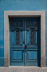 Fototapeta premium Portrait of gray door on blue wall background, beautiful architecture aesthetic concept