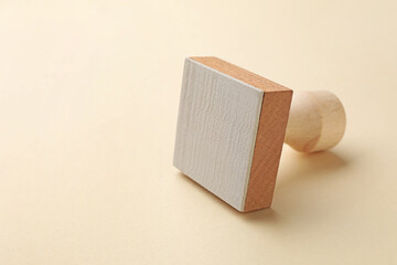 One wooden stamp on beige background, closeup. Space for text
