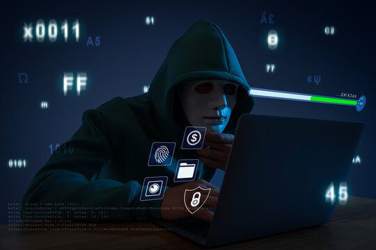 Cyber attack. Anonymous hacker in mask using laptop at table. Different icons on virtual screen