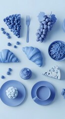 A monochromatic blue still life arrangement featuring grapes, croissants, a cupcake, pasta, and various plates and utensils on a light blue background
