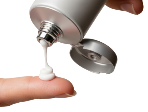 A swirl of white cream being squeezed from a silver tube directly onto a finger, against a clean white background