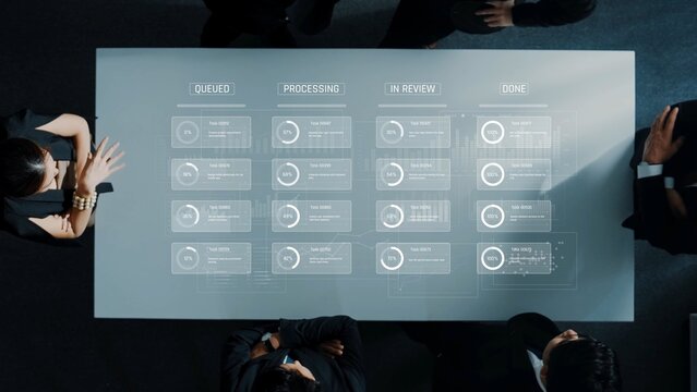 A modern meeting setup featuring a table with a digital display that illustrates project status and workflow, highlighting collaboration and data-driven decision-making. Raster