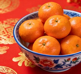 Mandarin Oranges in Decorative Bowl on Red Chinese New Year Background