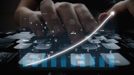 A close-up image of hands typing on a keyboard with digital financial graphs and data overlay, showcasing the intersection of technology and finance in business. Copula