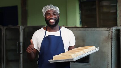 Local African baker entrepreneur, small business owner, proudly holds trays of freshly baked bread, showcasing his successful SME