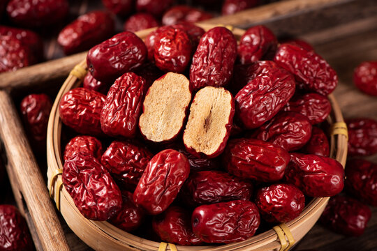 dried red dates on wooden table.
