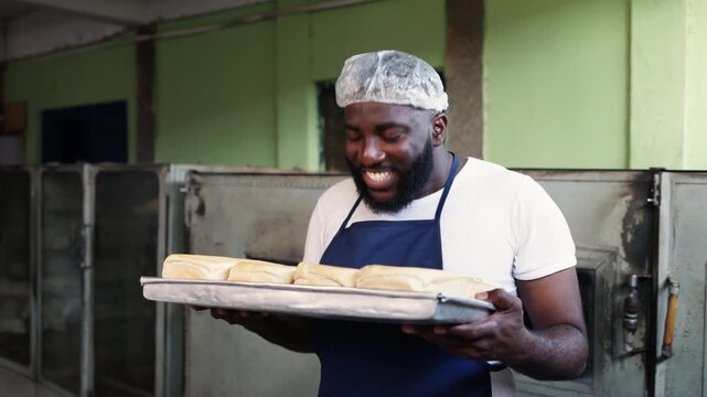 African baker entrepreneur, small business owner enjoying the aroma of freshly baked bread with satisfaction, proud SME success