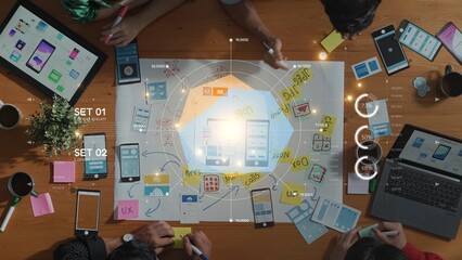 A diverse team collaborates on a design project in a modern workspace, engaged in brainstorming, prototyping smartphone designs while utilizing digital tools and feedback. Raster