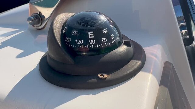 Close Up Shot Of A Nautical Navigation Compass On A Luxury Yacht Sailing Out To Sea.