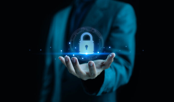 Businessman holding glowing padlock icon representing cybersecurity, data protection, privacy, and secure technology. Concept for digital security, network safety, and business information protection.