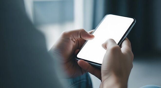 Closeup of hands holding a modern smartphone with a blank white screen, ready for use mockup background image