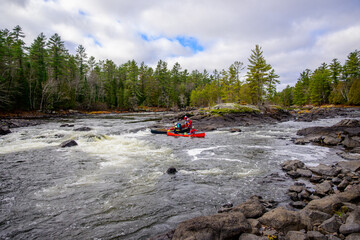 Teamwork: adventure guides work together to move their canoes safely down a rapid on the Madawaska River in Ontario late in the fall room for text