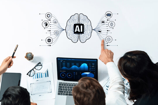 A diverse group of professionals collaborates in a modern workspace, focusing on innovative artificial intelligence concepts with data analysis presented on a laptop. Trope - Powered by Adobe