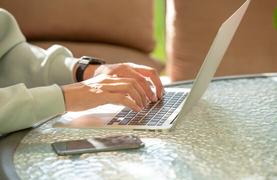 male hands typing on laptop keyboard - Powered by Adobe