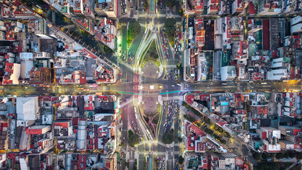 Aerial top-down view of Obelisco with traffic light trails at night, Buenos Aires, Argentina.
