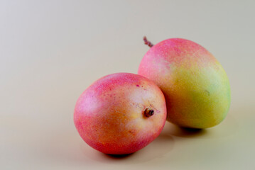 Closeup of mangoes on a yellow background