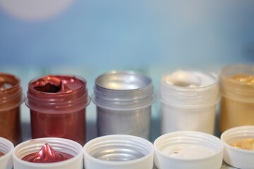 Paints in plastic containers photo different colors	