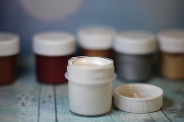 Paints in plastic containers photo different colors	
