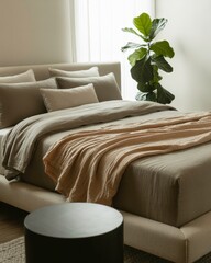 Cozy Neutral Bed Setup With Layered Linens, Plant, and Soft Natural Light
