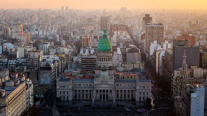 Aerial sunset view of National Congress building with green dome and Buenos Aires cityscape, Argentina.
