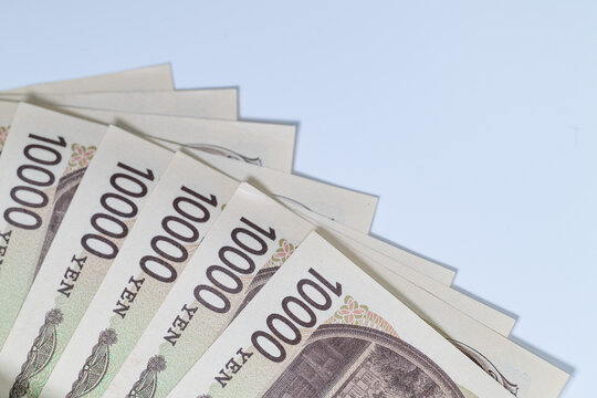 Close up of multiple japanese 10000 yen banknotes fanned out
