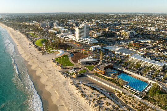 Aerial view of a busy coastal suburb and beachside precinct