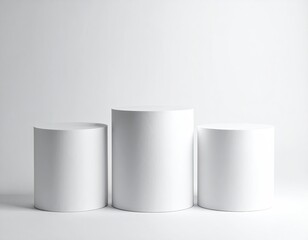 Three white cylinder stands on white. Studio lighting