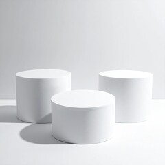Three white cylinders on a white background, shadows