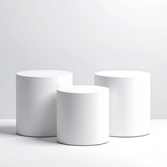 Three white cylinders on a white surface