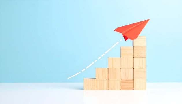 Red paper plane flying upward on staircase steps symbolizing business growth, success, and career progress.