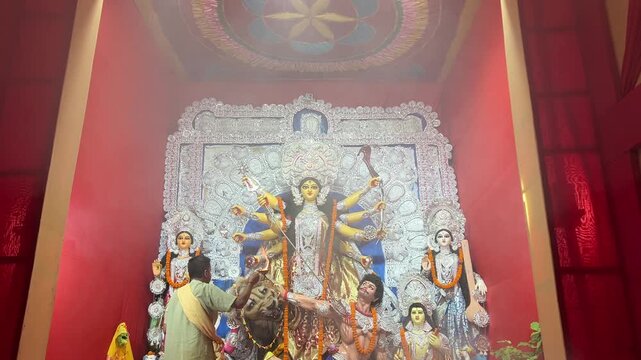 Priest performing Sandhya Arti at a Durga Puja Pandal in Kolkata