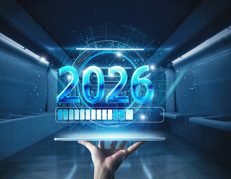 Exciting 2026 futuristic technology loading with hand holding device, new beginnings and innovation for future, success and progress in technology