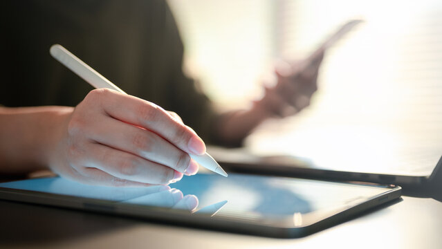 tablet, analysis, data, report, finance, planning, audit, Hand using stylus on tablet with blank screen in office environment, representing digital document management, data analysis, and planning.