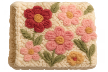 Handmade crochet floral textile with colorful knitted flowers and green leaves on an off-white wool background, transparent png