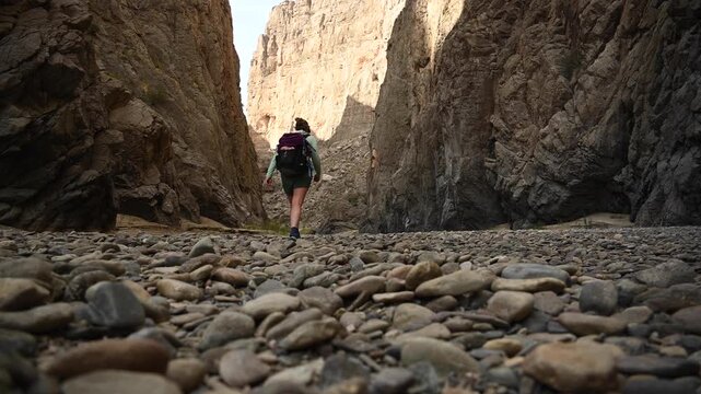 Woman Hikes Over Rocks into Mariscal Canyon in Big Bend National Park