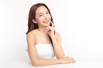 A beautiful young Asian woman with clean, fresh skin against a white background. Skincare, facial treatment, cosmetology, beauty, and spa. An elegant portrait of an Asian woman.