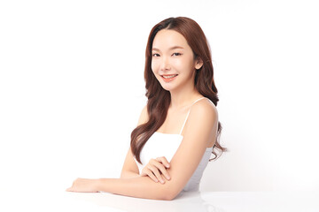 A beautiful young Asian woman with clean, fresh skin against a white background. Skincare, facial treatment, cosmetology, beauty, and spa. An elegant portrait of an Asian woman.