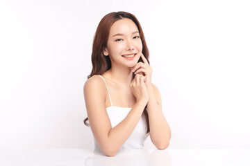 A beautiful young Asian woman with clean, fresh skin against a white background. Skincare, facial treatment, cosmetology, beauty, and spa. An elegant portrait of an Asian woman.
