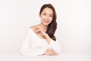 A beautiful young Asian woman with clean, fresh skin against a white background. Skincare, facial treatment, cosmetology, beauty, and spa. An elegant portrait of an Asian woman.
