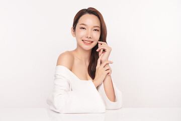 A beautiful young Asian woman with clean, fresh skin against a white background. Skincare, facial treatment, cosmetology, beauty, and spa. An elegant portrait of an Asian woman.
